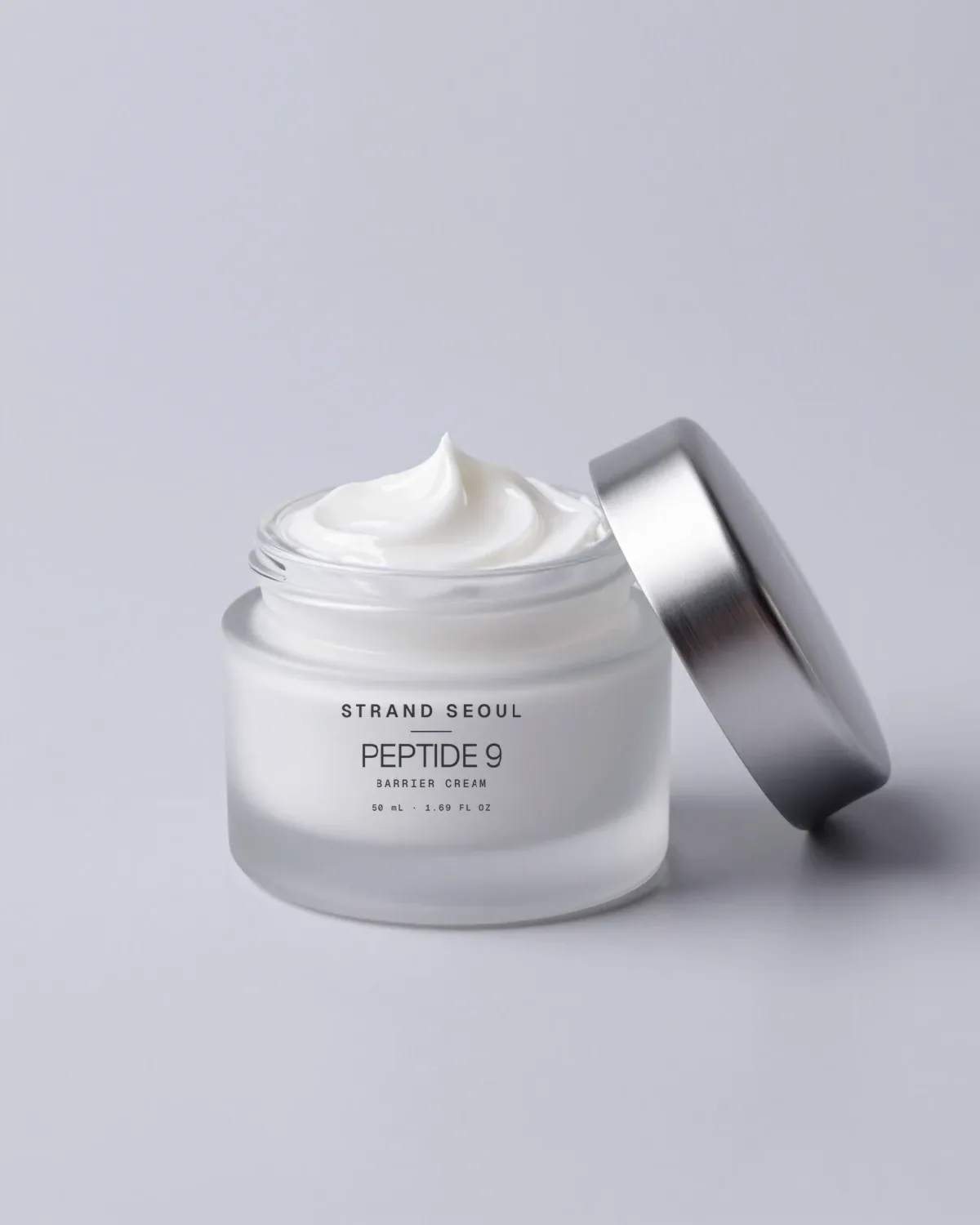 Peptide 9 Barrier Cream: a frosted glass jar with a silver lid