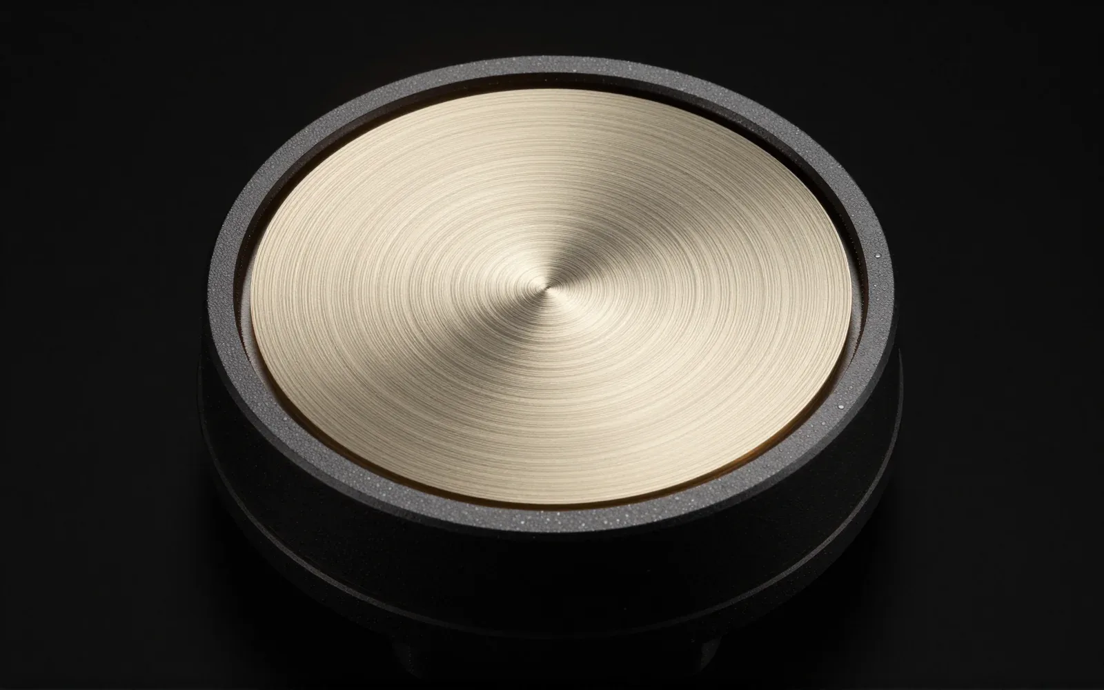 The 40 mm driver, its champagne-gold dome lit from the side