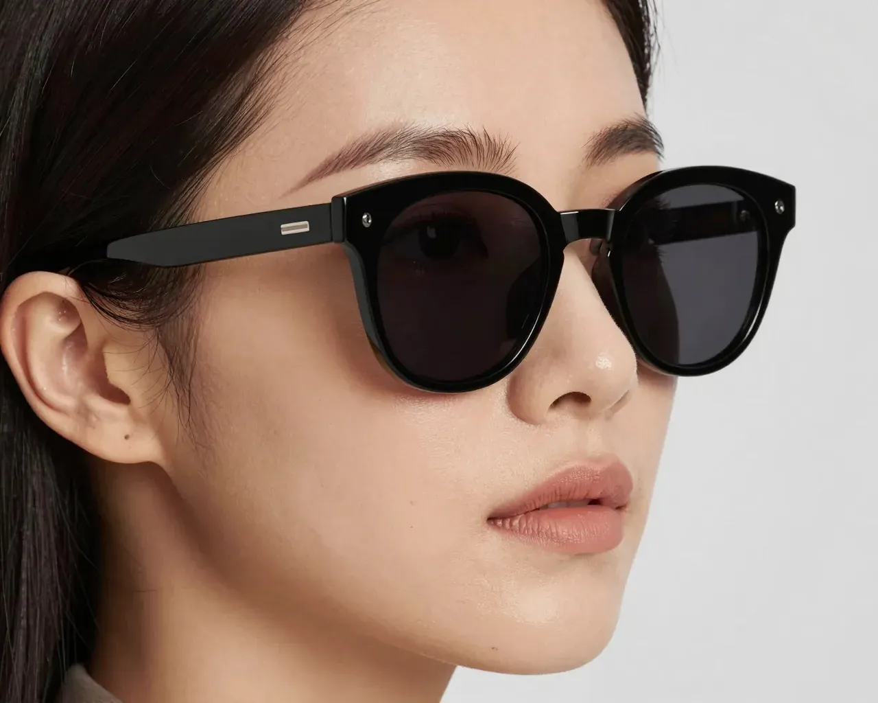 A Korean woman wearing ECLIPSE 01 in the Asian fit: the bridge rests higher on her nose and the frame clears her cheek