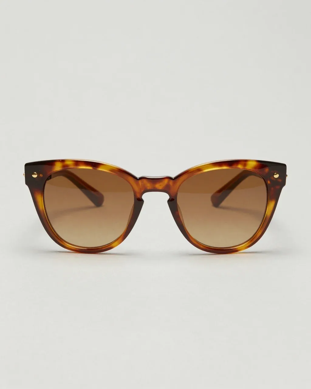 PERIHELION from the front, amber tortoiseshell cat-eye sunglasses with brown gradient lenses