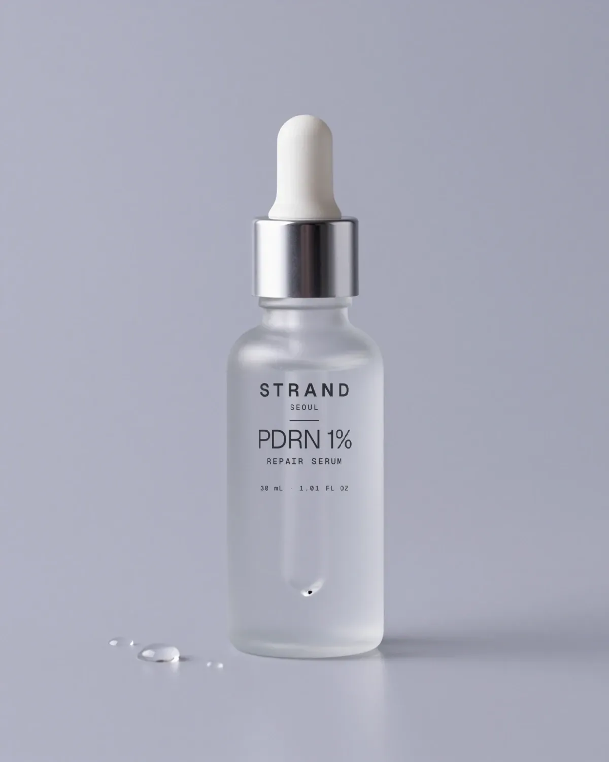 PDRN 1% Repair Serum: a frosted glass dropper bottle with a silver collar
